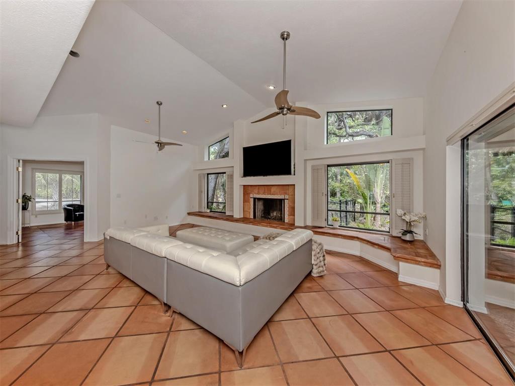 2602 Firetree Lane Venice, FL 34292 - Photo 5 of 31 a living room with a large window and a fireplace