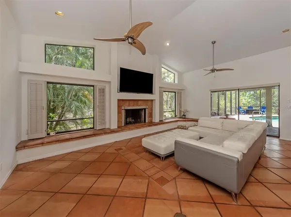 a living room with furniture a flat screen tv and a fireplace
