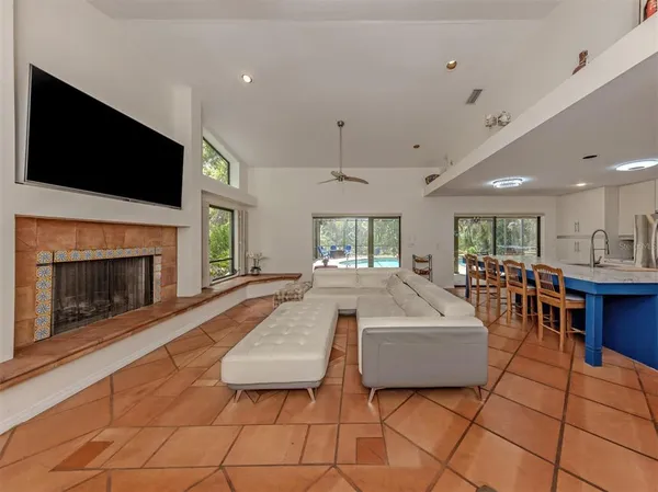 a living room with furniture a flat screen tv and a fireplace
