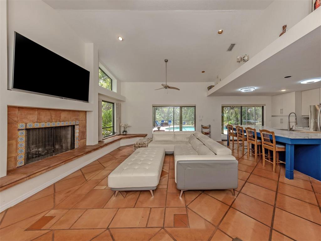 2602 Firetree Lane Venice, FL 34292 - Photo 7 of 31 a living room with furniture a flat screen tv and a fireplace
