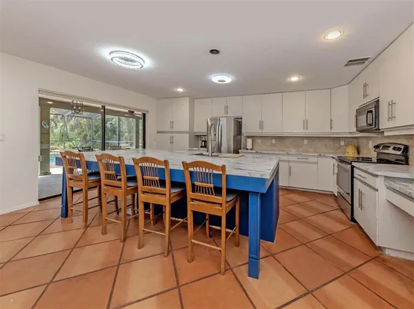 a large kitchen with lots of table and chairs