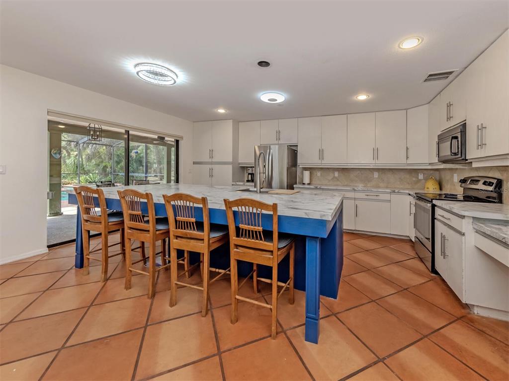 2602 Firetree Lane Venice, FL 34292 - Photo 8 of 31 a large kitchen with lots of table and chairs