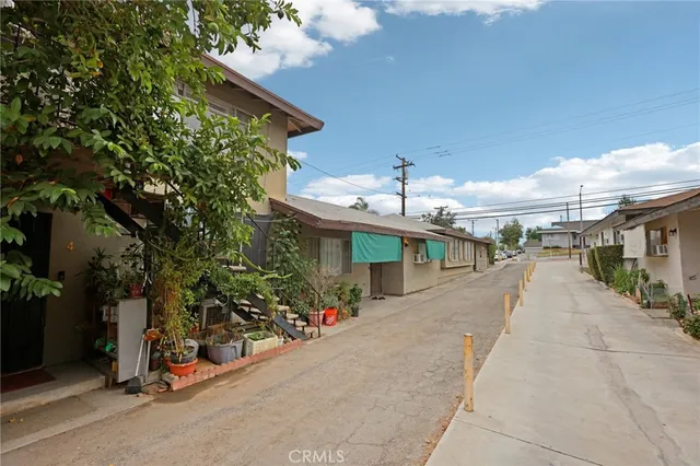 an outdoor space with lots of potted plants