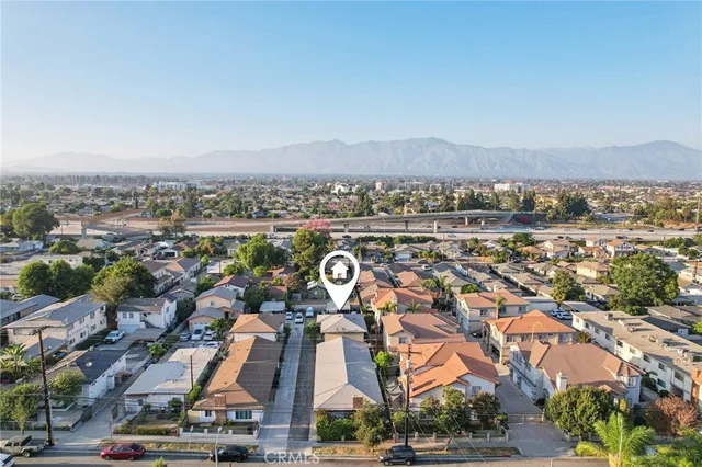 an aerial view of residential houses with outdoor space and street view