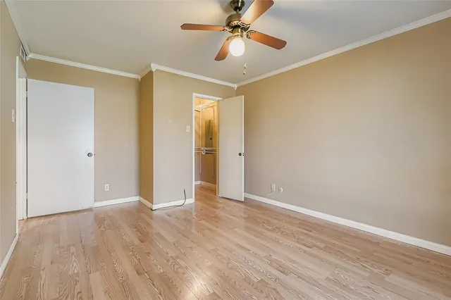 a view of an empty room and wooden floor