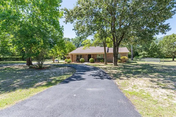 a front view of house with yard and green space