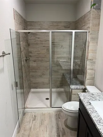 a bathroom with a shower and a toilet