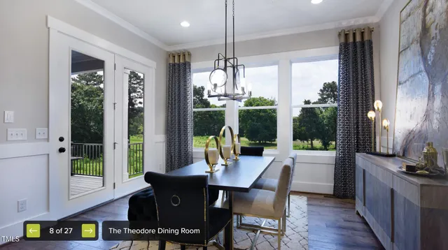 a dining room with furniture a chandelier and wooden floor