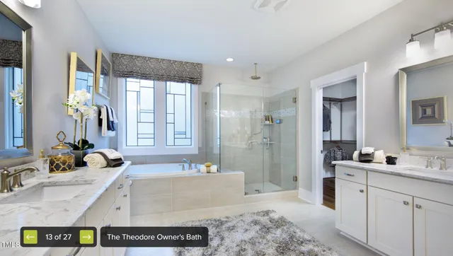 a spacious bathroom with sink shower and mirror