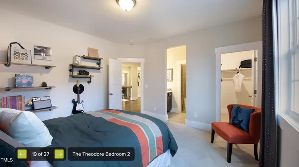 a bedroom with furniture and a lamp