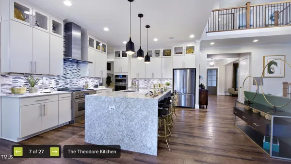 a large kitchen with stainless steel appliances refrigerator a stove a sink dishwasher and wooden cabinets with wooden floor