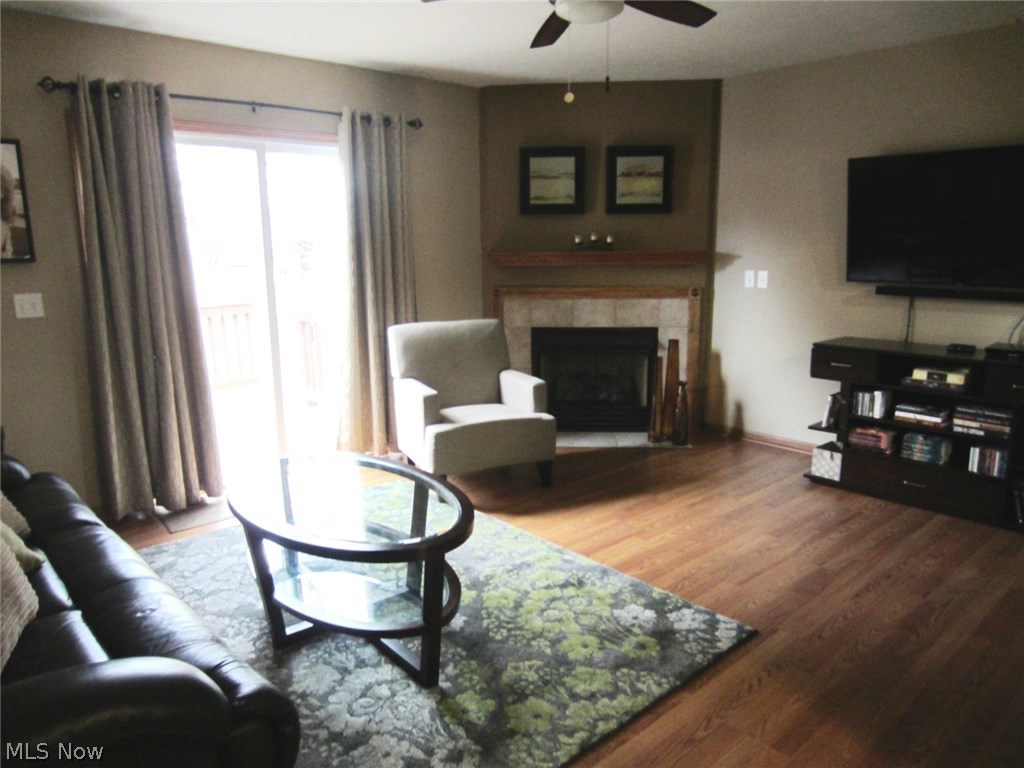 1202 Windmill Way South Avon, OH 44011 - Photo 5 of 23 Living Room w/New Flooring, Gas Fireplace and Sliding Door that opens to Private Deck.