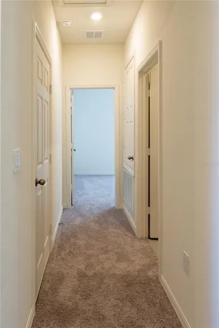 a view of a hallway with wooden shelves