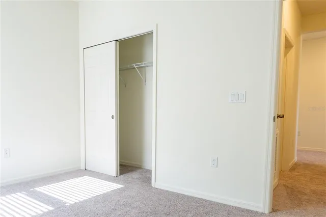 an empty room with windows and closet