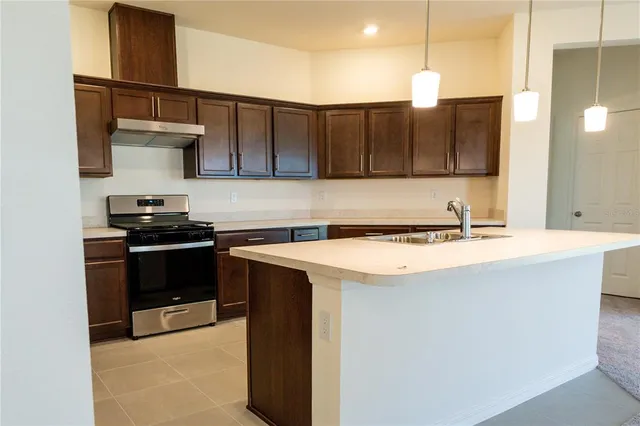 a kitchen with a sink and wooden cabinets
