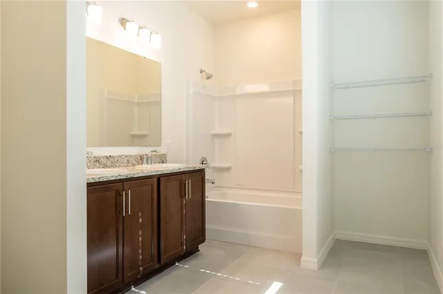 a bathroom with a granite countertop sink toilet and mirror