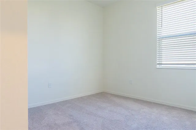 a view of an empty room and a window