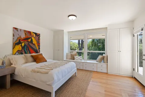 a bedroom with a bed and a large window