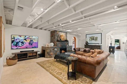 a living room with fireplace furniture and a flat screen tv