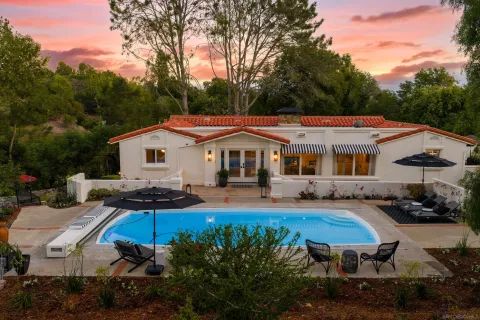 a house with swimming pool in front of it