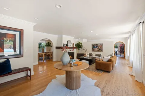 a living room with furniture a rug and a window