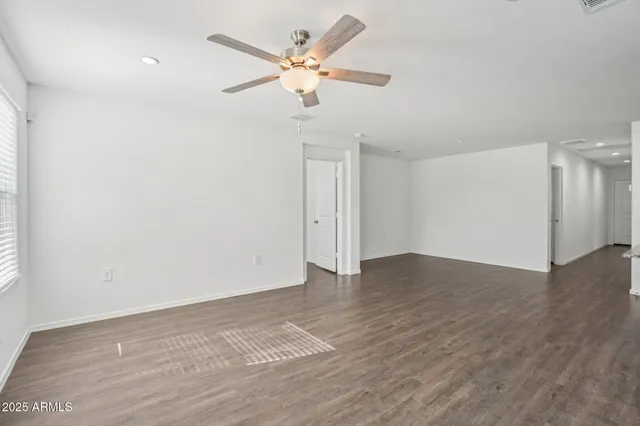 a kitchen with kitchen island granite countertop a sink a stove and cabinets