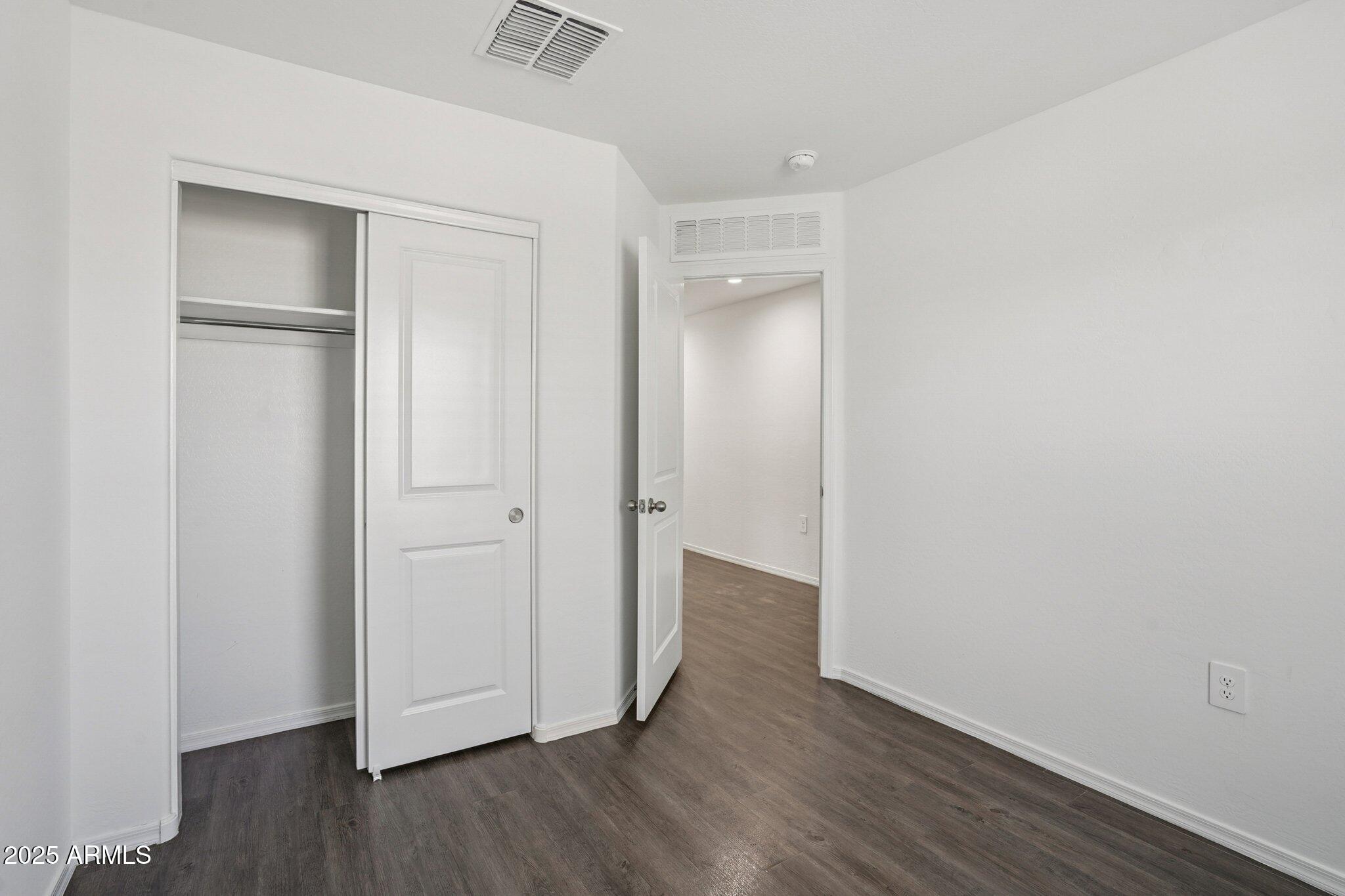 1566 East Yeoman Drive Casa Grande, AZ 85122 - Photo 15 of 28 a view of an empty room with wooden floor