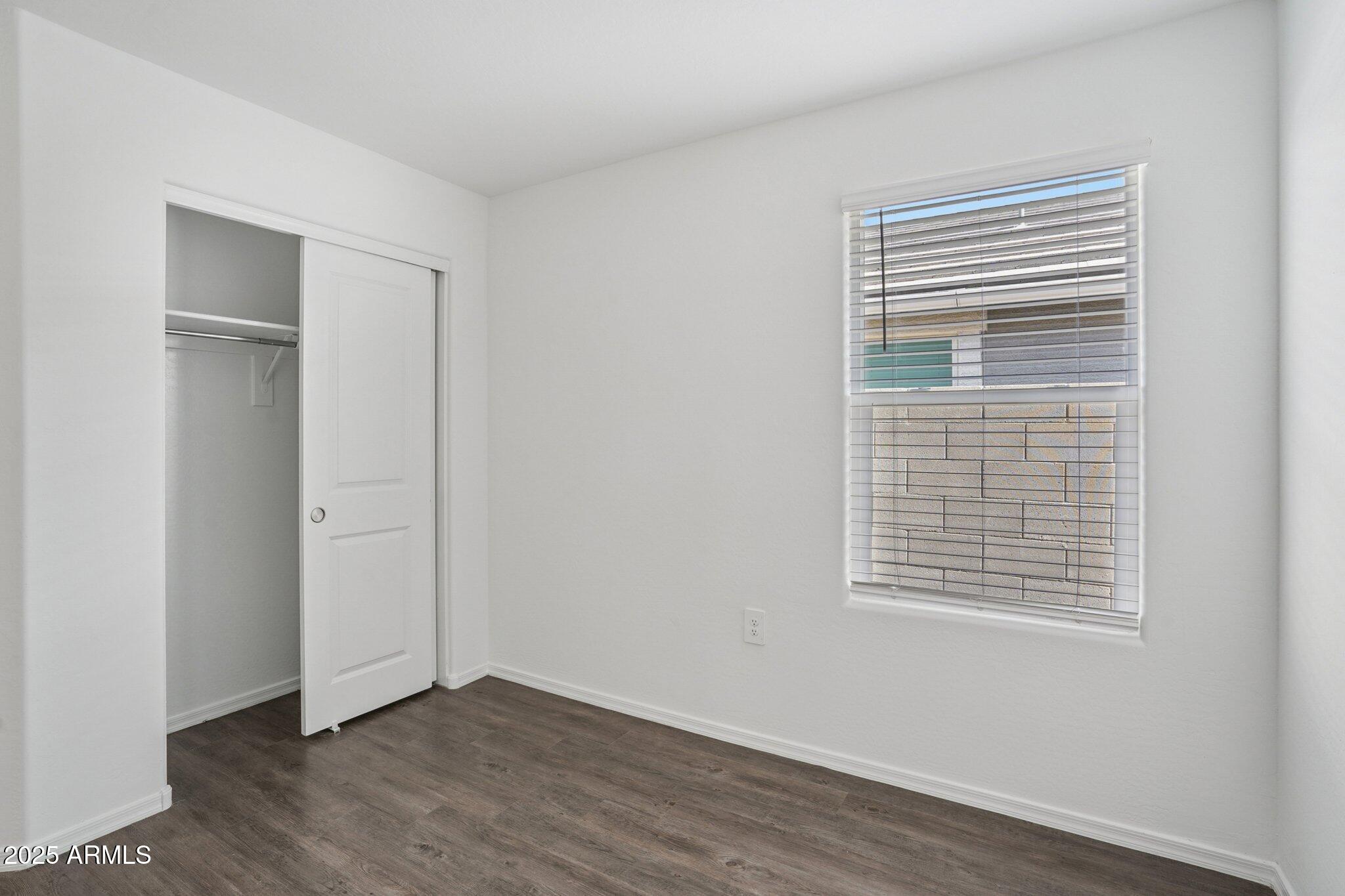 1566 East Yeoman Drive Casa Grande, AZ 85122 - Photo 16 of 28 a view of an empty room with wooden floor and a window
