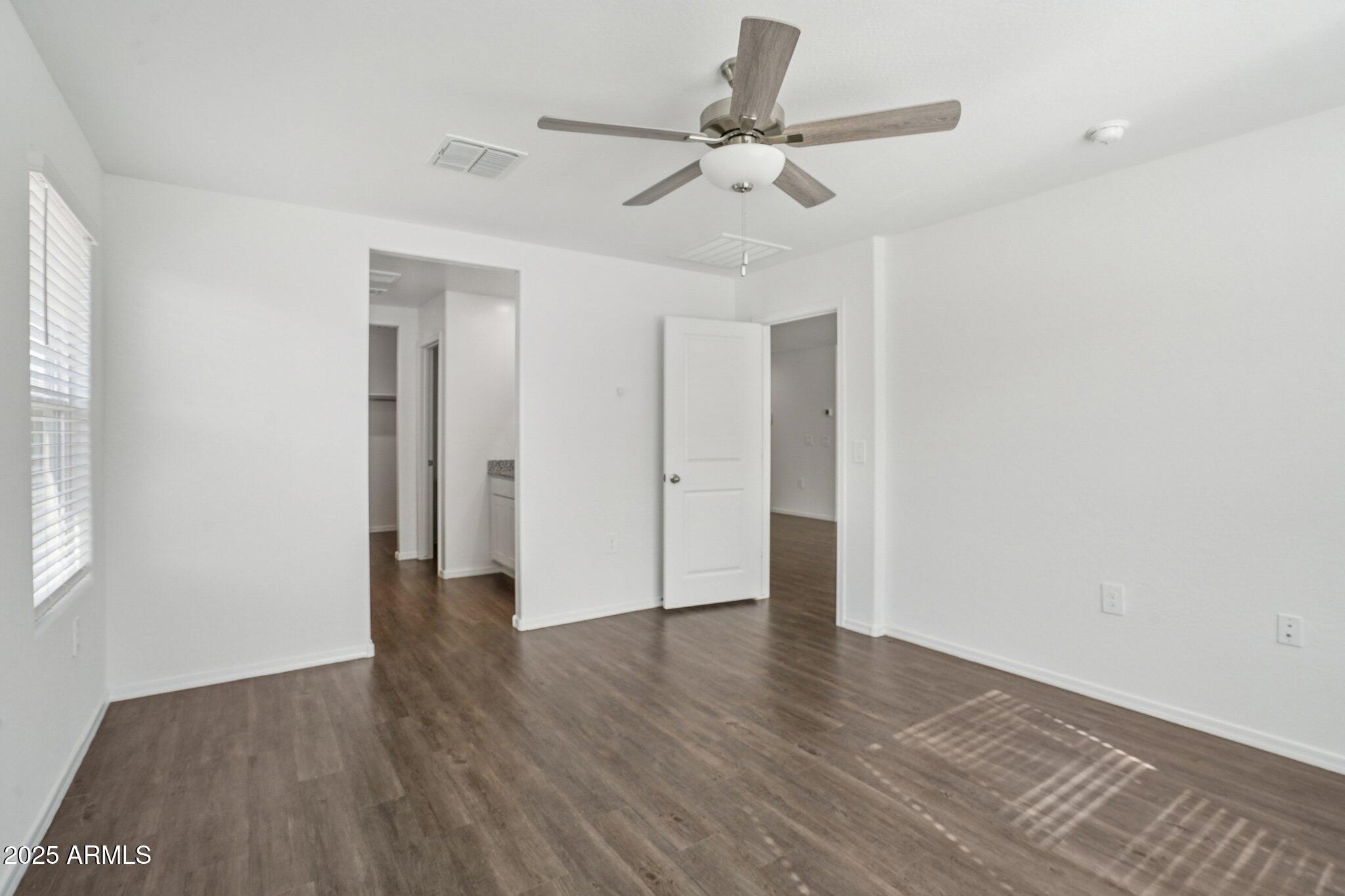 1566 East Yeoman Drive Casa Grande, AZ 85122 - Photo 19 of 28 an empty room with wooden floor and windows