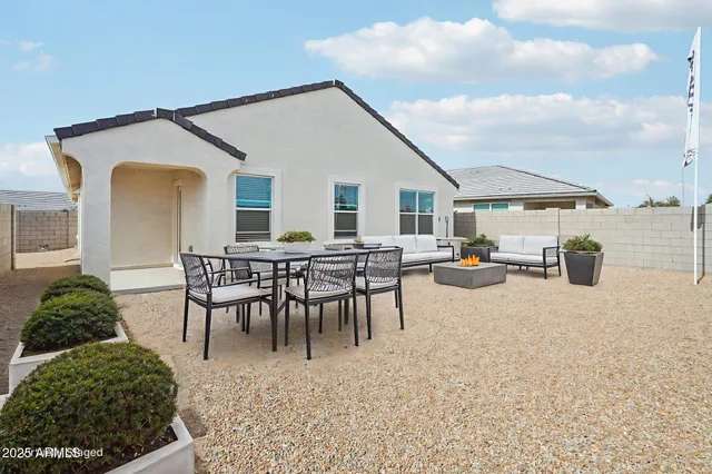 a living room with furniture a flat screen tv and a window