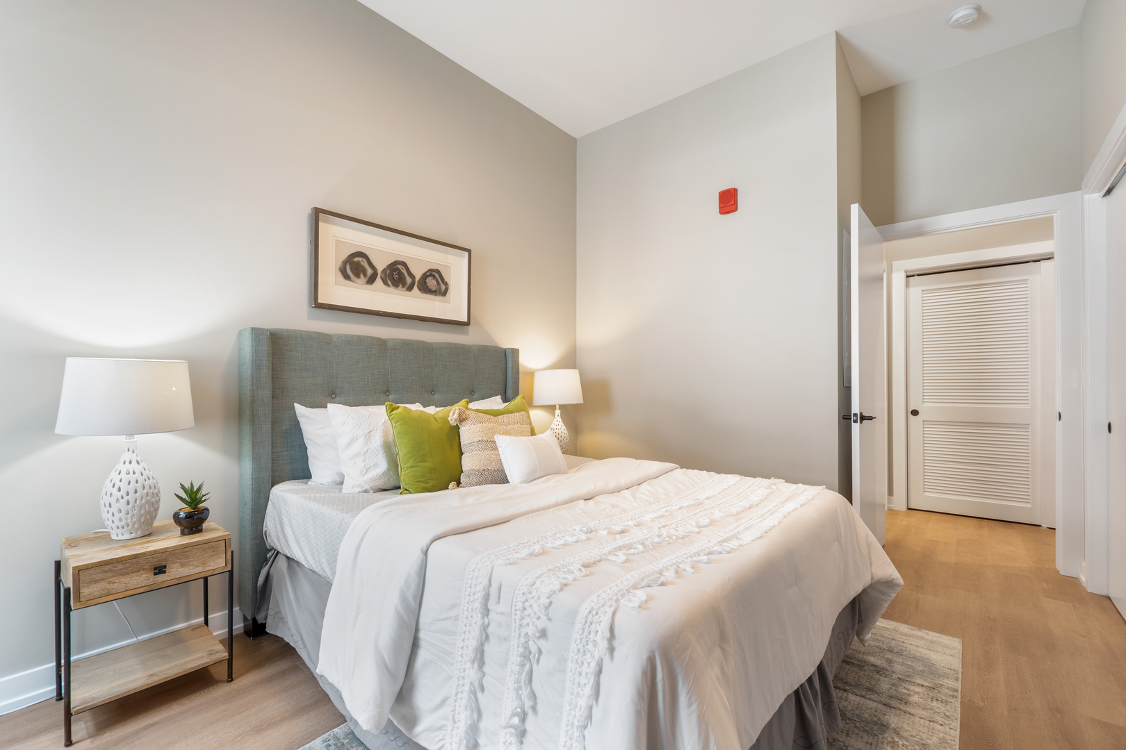 3217 North Clark Street, Unit 504 Chicago, IL 60657 - Photo 13 of 28 a bedroom with a bed and a night stand