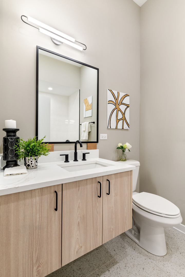 3217 North Clark Street, Unit 504 Chicago, IL 60657 - Photo 16 of 28 a bathroom with a toilet sink and mirror