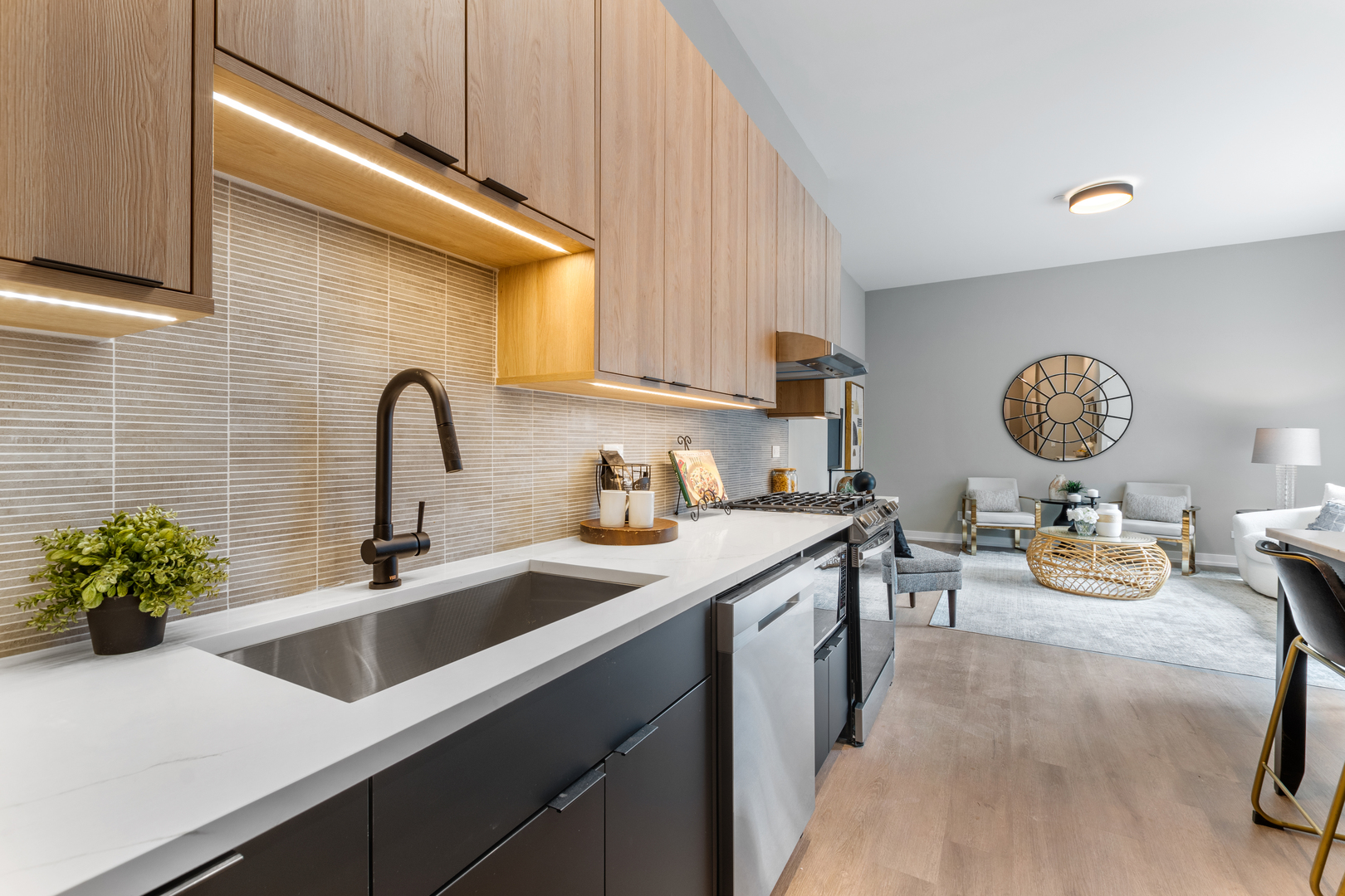 3217 North Clark Street, Unit 504 Chicago, IL 60657 - Photo 2 of 28 a kitchen with a sink a counter and chairs in it