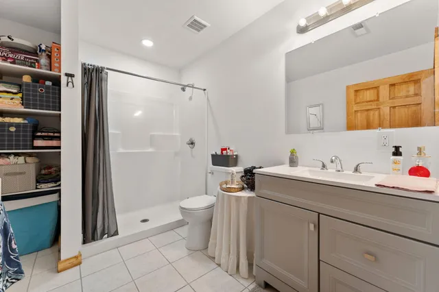 a bedroom with a bed a couch and a window