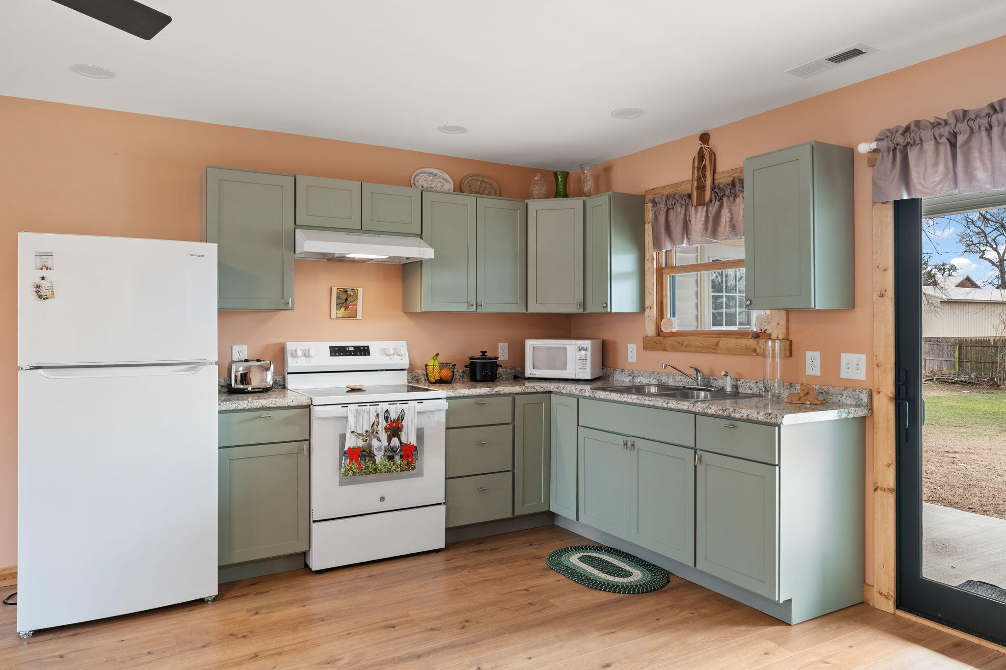 25 East Grove Street Wheatfield, IN 46392 - Photo 7 of 21 a kitchen with a stove top oven and refrigerator