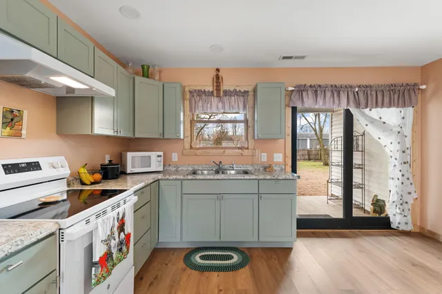 a kitchen with stainless steel appliances granite countertop a stove and a sink