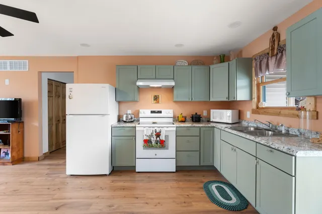 a kitchen with a refrigerator and a sink