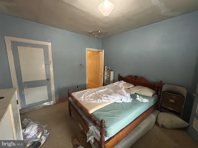 a bed sitting in a bedroom next to a window