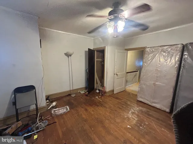 a view of a room with gym equipment and a chandelier