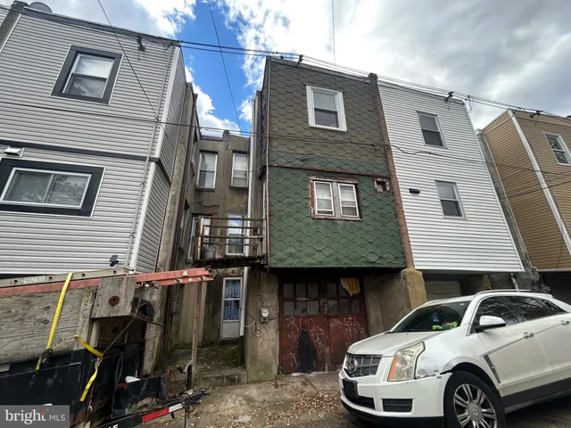 a front view of a house with parking space
