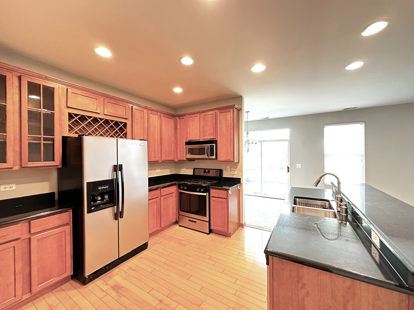 24252 Leski Lane Plainfield, IL 60585 - Photo 2 of 11 a kitchen with stainless steel appliances granite countertop a refrigerator stove sink and dishwasher