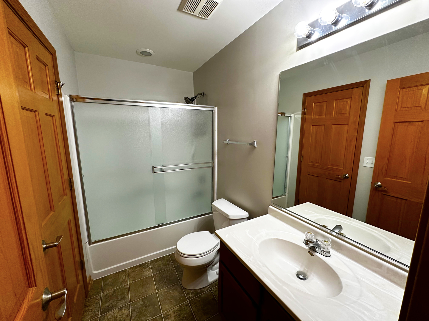 24252 Leski Lane Plainfield, IL 60585 - Photo 9 of 11 a bathroom with a sink a toilet a mirror and shower