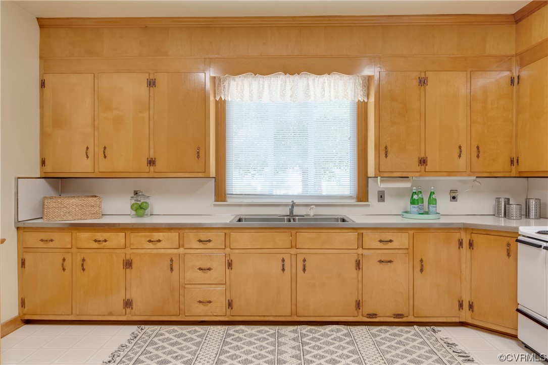 1700 Midview Road Henrico, VA 23231 - Photo 29 of 50 a kitchen with granite countertop a sink a stove and cabinets