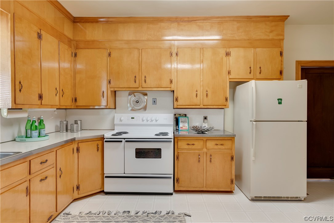 1700 Midview Road Henrico, VA 23231 - Photo 31 of 50 a kitchen with a sink a stove and white cabinets