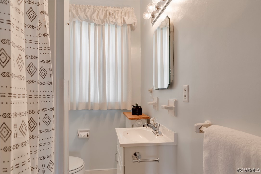 1700 Midview Road Henrico, VA 23231 - Photo 43 of 50 a bathroom with a sink a toilet and mirror