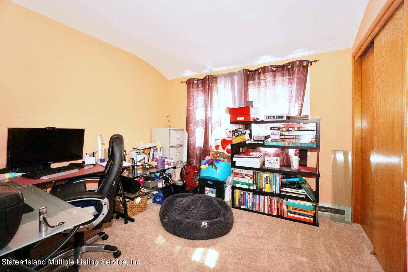 563 Mill Road Staten Island, NY 10306 - Photo 12 of 32 a room with musical instruments and book shelf
