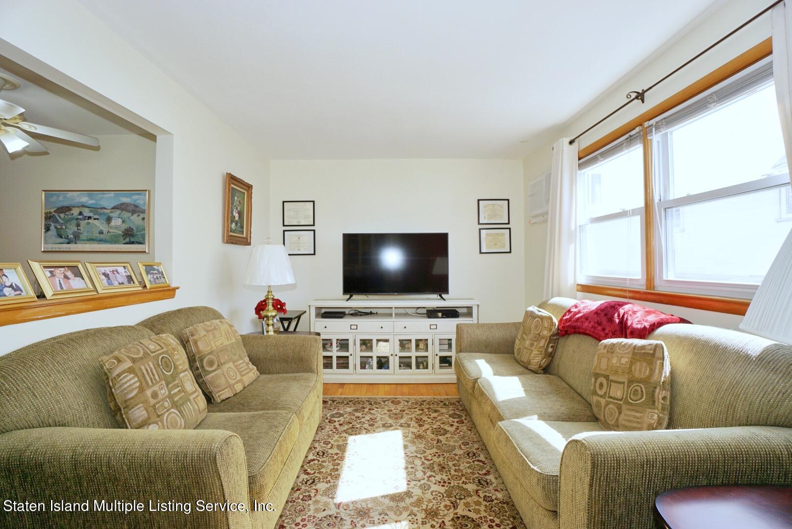 563 Mill Road Staten Island, NY 10306 - Photo 14 of 32 a living room with furniture and a flat screen tv