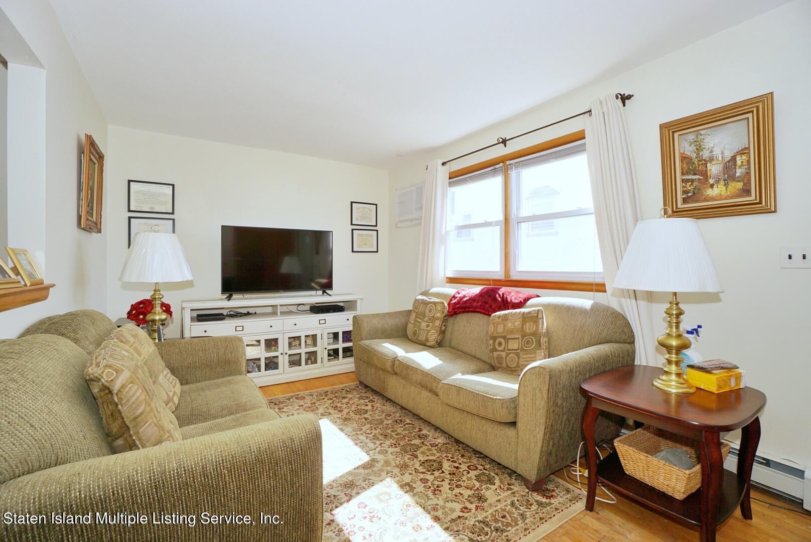 563 Mill Road Staten Island, NY 10306 - Photo 15 of 32 a living room with furniture and a flat screen tv