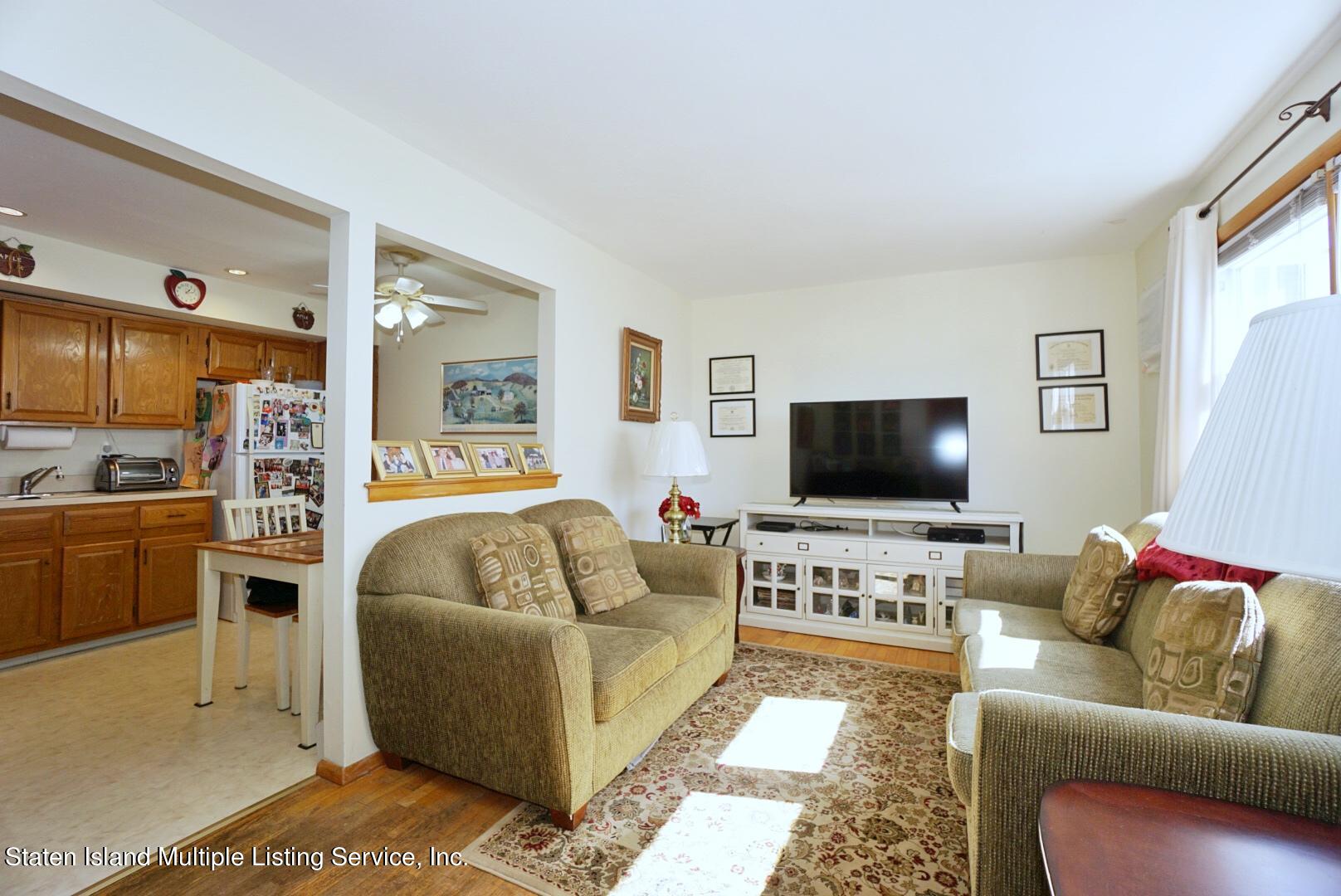 563 Mill Road Staten Island, NY 10306 - Photo 16 of 32 a living room with furniture and a flat screen tv