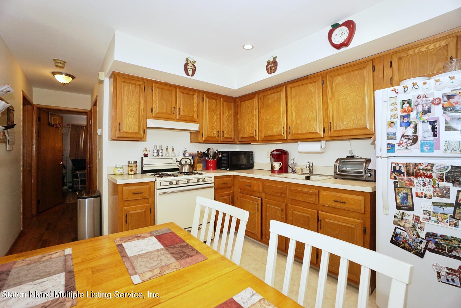 563 Mill Road Staten Island, NY 10306 - Photo 18 of 32 a kitchen with stainless steel appliances granite countertop a sink and cabinets